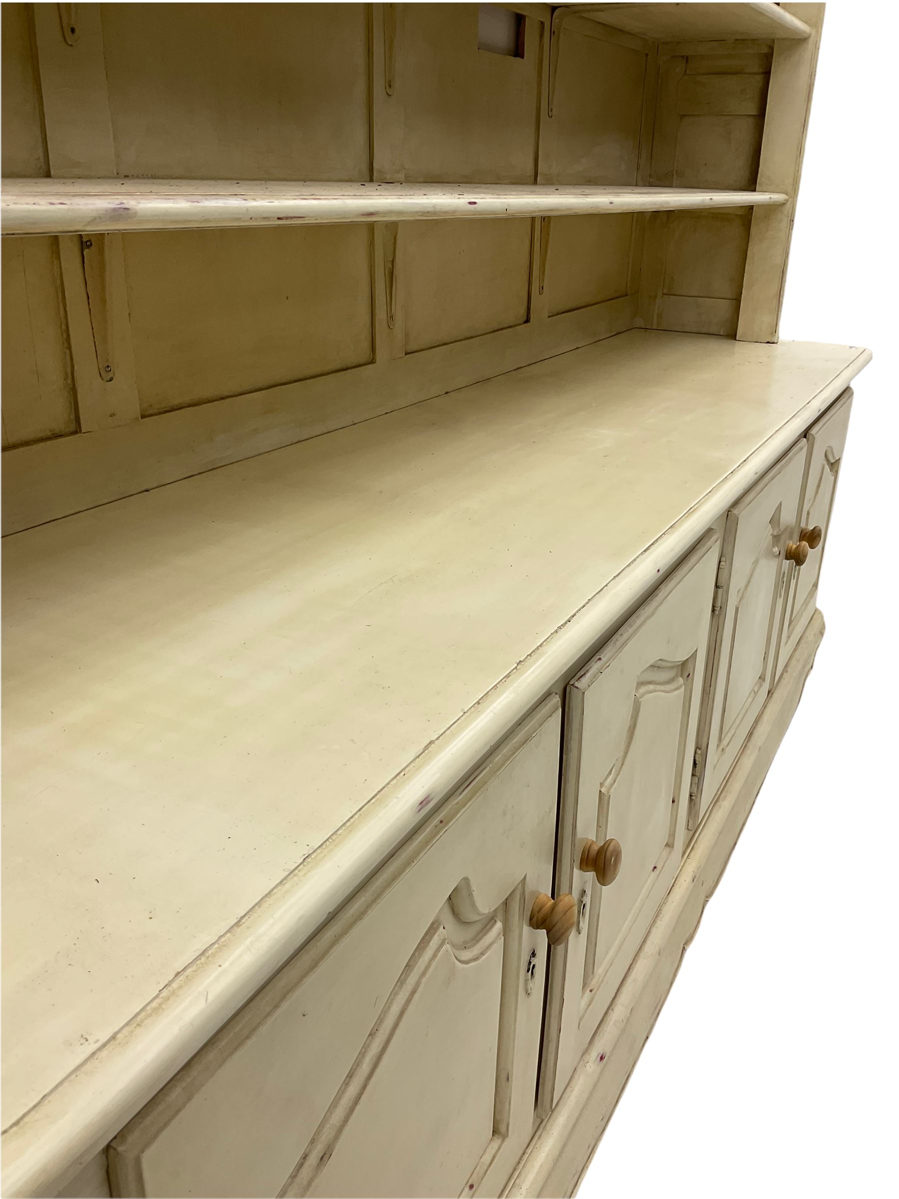 Large French style cream painted dresser, fitted with four cupboards and three tier plate rack