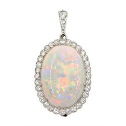 Early-mid 20th century platinum opal and diamond cluster pendant/brooch, the oval cabochon opal in a surround of old cut diamonds, milgrain set with detachable diamond bail

Notes: By direct decent from the Barraclough family. Zachariah Barraclough & Sons jewellers and silversmiths were established in Leeds in 1805 and in 1914 become a limited company