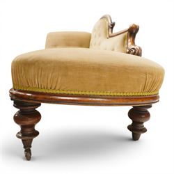 Victorian mahogany framed chaise longue, shaped button upholstered back with scroll-over end, padded seat and arm, moulded frame with carved scroll decoration, on turned supports with brass castors