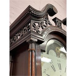 Early George III mahogany longcase clock, the hood having broken swan neck and dentil pediment with open fretwork panels on stepped arch, cluster column pilasters, glazed door enclosing painted enamel dial with moon phase, Roman and Arabic chapter ring with subsidiary seconds dial and date aperture, the spandrels decorated with raised gilt scroll and flower head decoration, eight day movement striking on bell, pointed ogee arch and moulded trunk door flanked by full turned stop fluted pilasters, the base having applied interlacing foliate decoration and simulated brick canted corners, raised on ogee canted bracket feet carved with flower heads