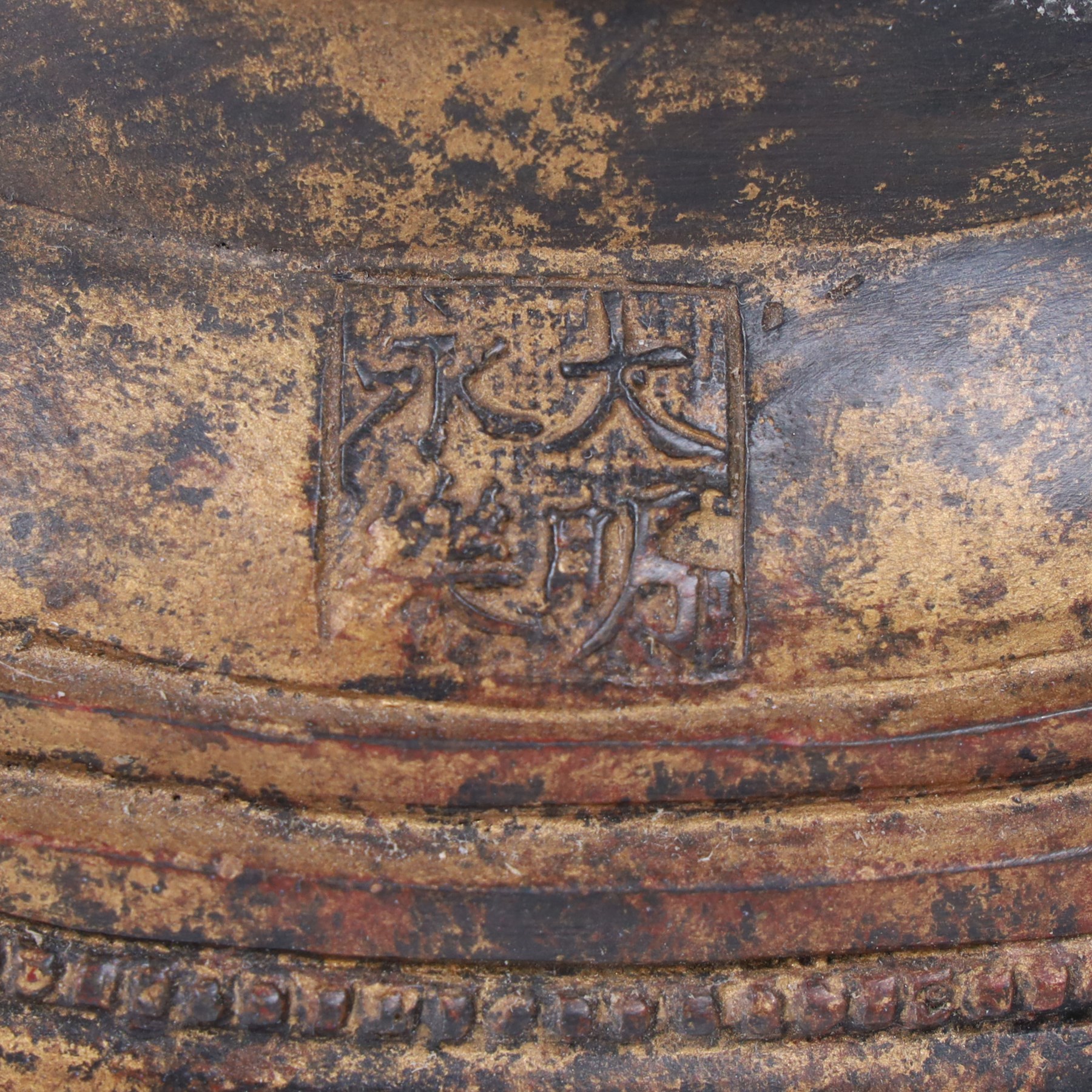 20th century bronzed buddha, with one hand raised, seated upon a lotus leaf, H27cm