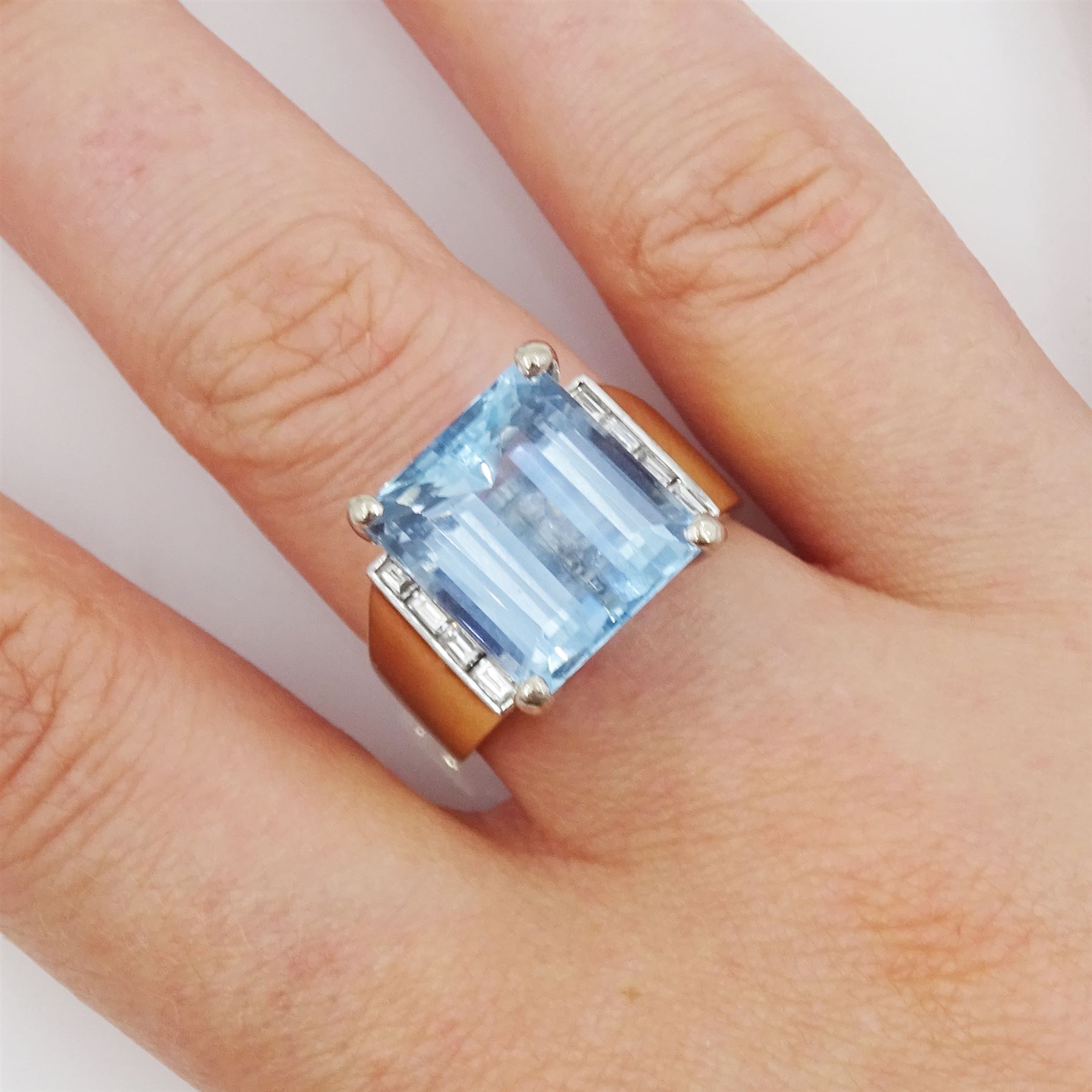 14ct gold aquamarine and diamond ring, emerald cut aquamarine with four baguette cut diamonds set either side, stamped 14K 585, aquamarine approx 6.55 carat