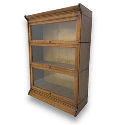 Early 20th century oak three-tier stacking library bookcase, enclosed by hinged and sliding glazed doors
