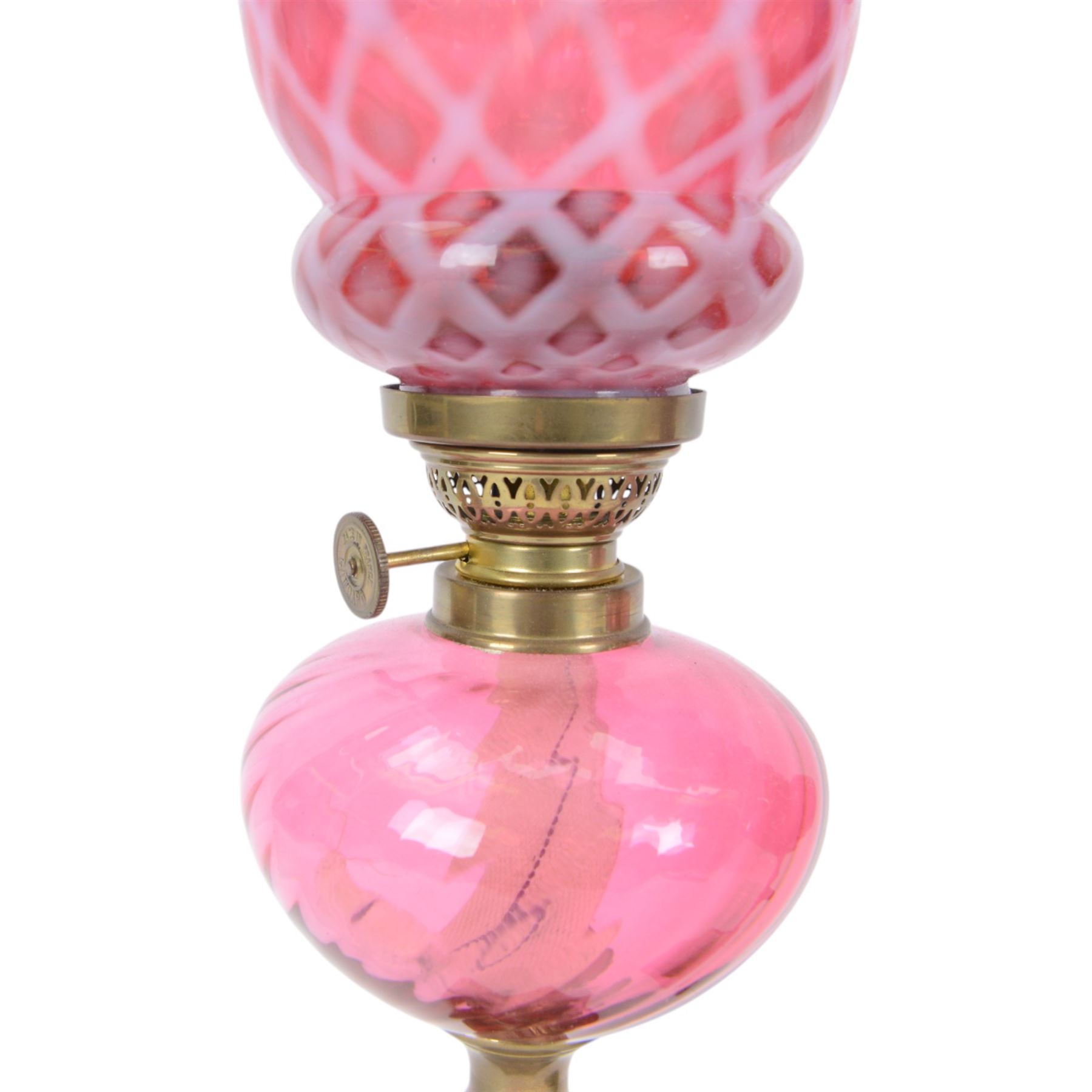 Pair of cranberry glass and brass oil lamps, with frilled graduated cranberry glass shade, cranberry reservoir with brass Gaudard burner, upon knopped column  with stepped square base, H46cm