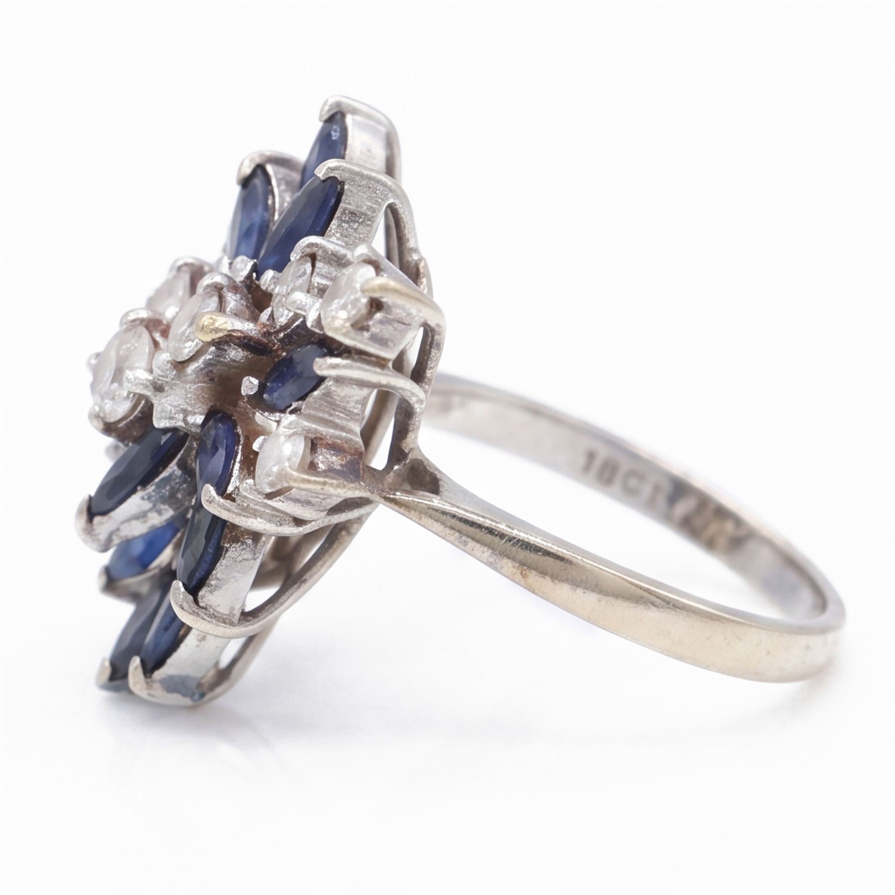White gold sapphire and diamond cluster ring, set with eight round brilliant cut diamonds and twelve marquise cut sapphires, stamped 18ct, total diamond weight approx 0.45 carat