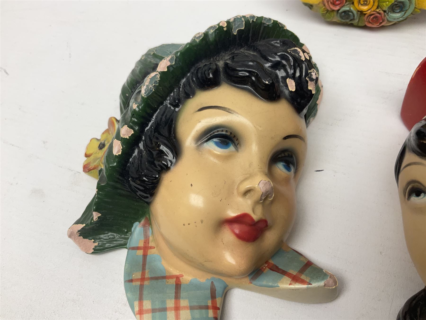 Art Deco plaster female bust, marked Arnova 353, together with a collection of wall masks 