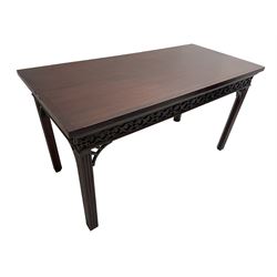 In the manner of Thomas Chippendale - early 19th century mahogany serving table, rectangular crossbanded top with boxwood stringing, the frieze with upper moulding over applied geometric fretwork, the left-hand side fitted with slide, on fluted square supports with inner chamfer 