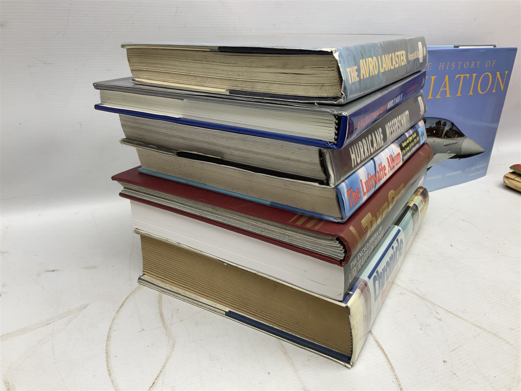 Ten books of predominantly military aircraft interest including Aircraft Anatomy World War Two, Hurricane Messerschmitt, The Avro Lancaster, The Luftwaffe Album, Encyclopaedia of Aircraft of WWII etc; together with a scrap album of WW2 newspaper cuttings