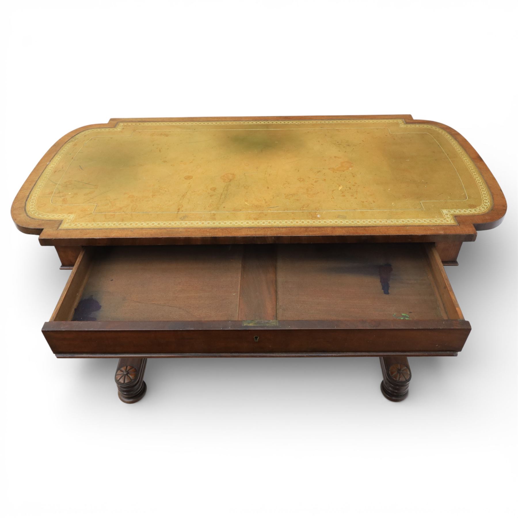 William IV mahogany library table, rectangular top with rounded edges inset with gilt and blind tooled leather writing surface, fitted with opposing frieze drawers, raised upon shaped trestle end supports united by a central upper stretcher, terminating in stylised bun feet with applied roundel bosses