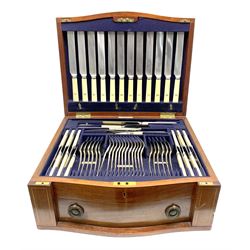 Late 19th/early 20th century composite canteen of silver flatware, contained within an early 20th century mahogany serpentine fronted case with twin drop carry handles, and hinged cover with boxwood stringing and central inlaid shell motif, above a single drawer with twin ring handles and Wellington style locking system, the cover and drawer opening to reveal plaque for Spink & Sons Ltd London, and fitted interior containing ivory handled knives, ivory handled carving set, and silver Hanoverian and Old English pattern cutlery, each with engraved monogram to terminal, hallmarked London, makers Spink & Son (John Marshall Spink), Goldsmiths & Silversmiths Co, and Chawner & Co (George William Adams), various dates ranging 1880-1923, gross weighable silver 92.59 ozt (2880 grams)