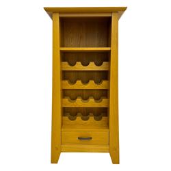 Contemporary light oak wine cabinet, rectangular overhanging top above an open shelf, fitted with four bottle racks each holding three bottles, single drawer with curved metal handle, on chamfered supports