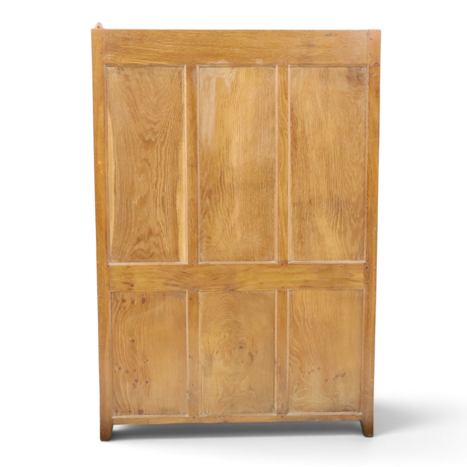 Rabbitman - oak glazed bookcase or display cabinet, lightly adzed rectangular top with raised gallery, twin glazed doors enclosing two shelves, over a pair of panelled cabinet doors with wrought iron fittings, with carved rabbit signature, by Peter Heap of Wetwang
