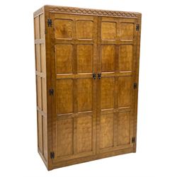 'Gnomeman' oak double wardrobe, enclosed by two panelled doors, the interior fitted with hanging rail, panelled sides and adzed all over,