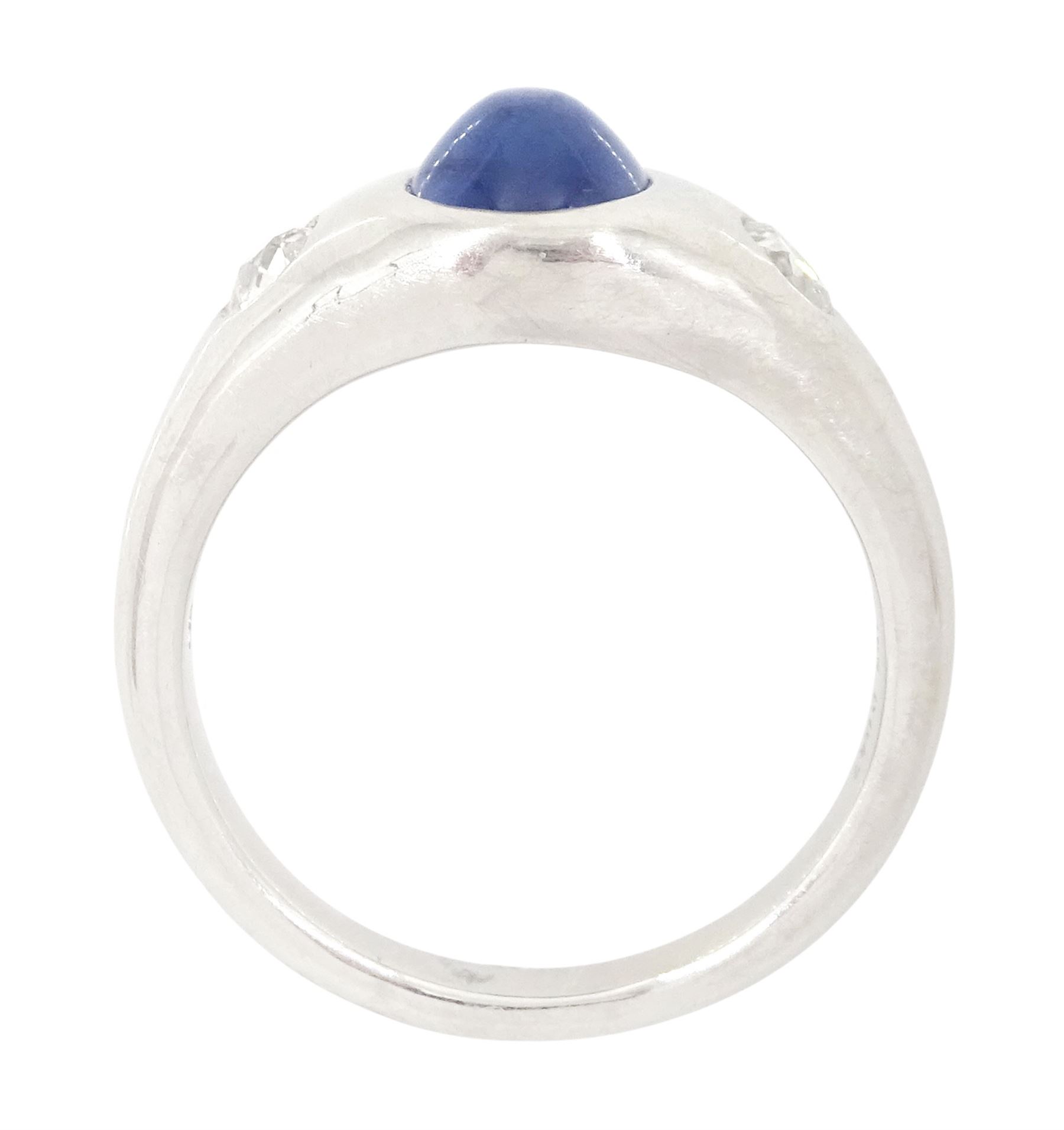 Platinum sapphire and diamond three stone ring, single cabochon sapphire of 1.65 carat, with a rubover set old cut diamond set either side, stamped 850 Plat, total diamond weight 0.42 carat