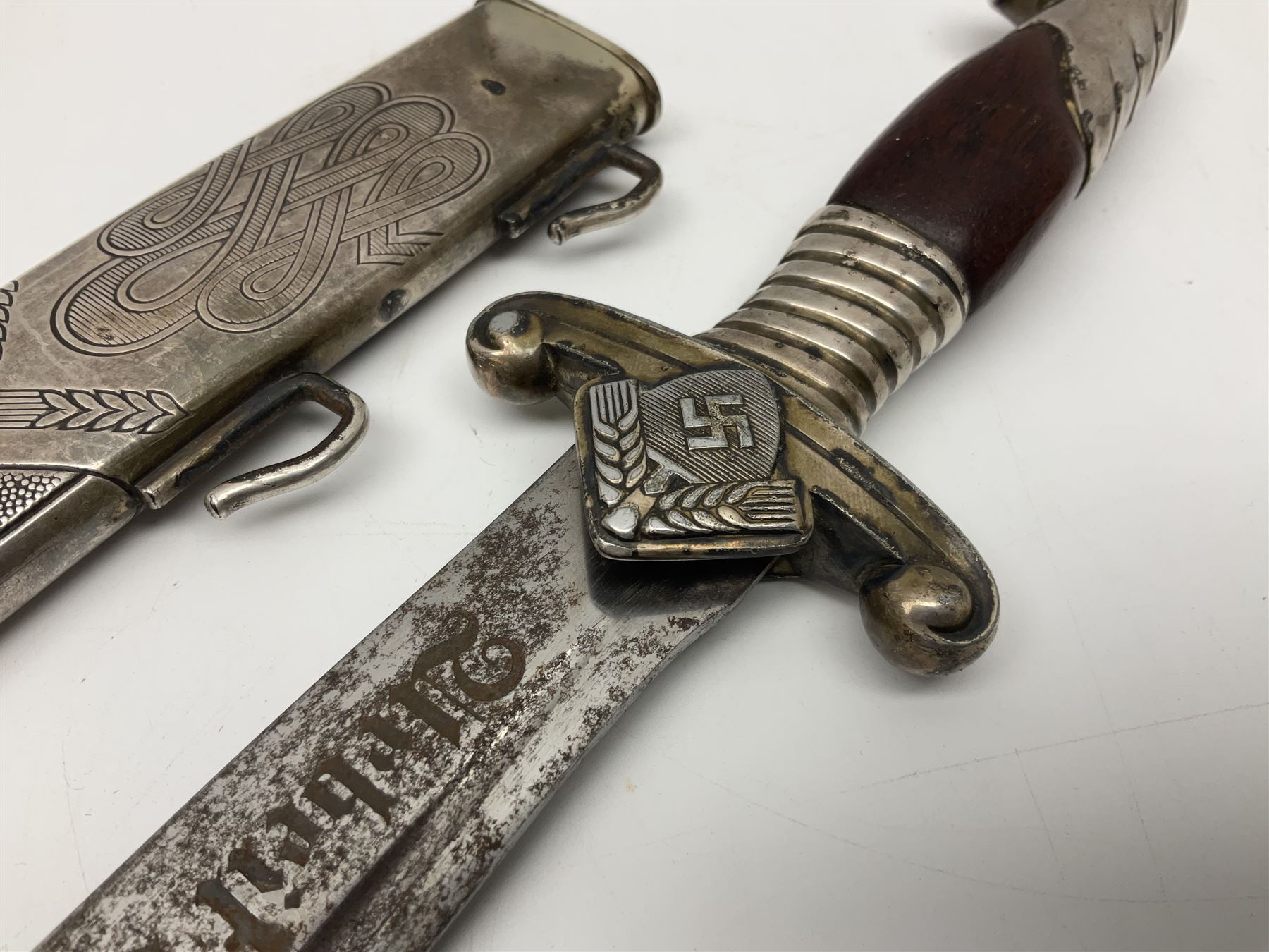 WW2 German RAD (Reichsarbeitdienst) Leader's hewer dagger,  the 25.5cm fullered steel blade engraved Arbeit Adelt (Work Enables) with Eickhorn squirrel maker's mark; scrolling cross-piece, mahogany grip and eagle pommel; in decorative plated scabbard L40cm overall.