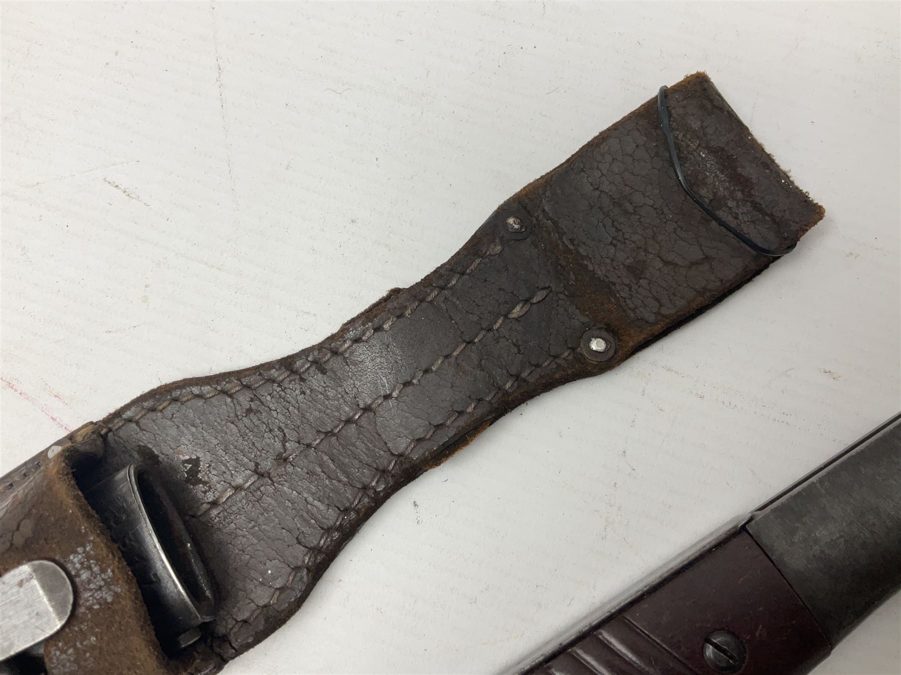 WWII German K98 Mauser bayonet by E. & F. Horster, the 24.5cm fullered blade marked 43aSW for 1943, numerous inspection marks to blade and pommel, bakelite grips and bluing to metal parts; in steel scabbard with corresponding numbers and leather frog L42cm overall