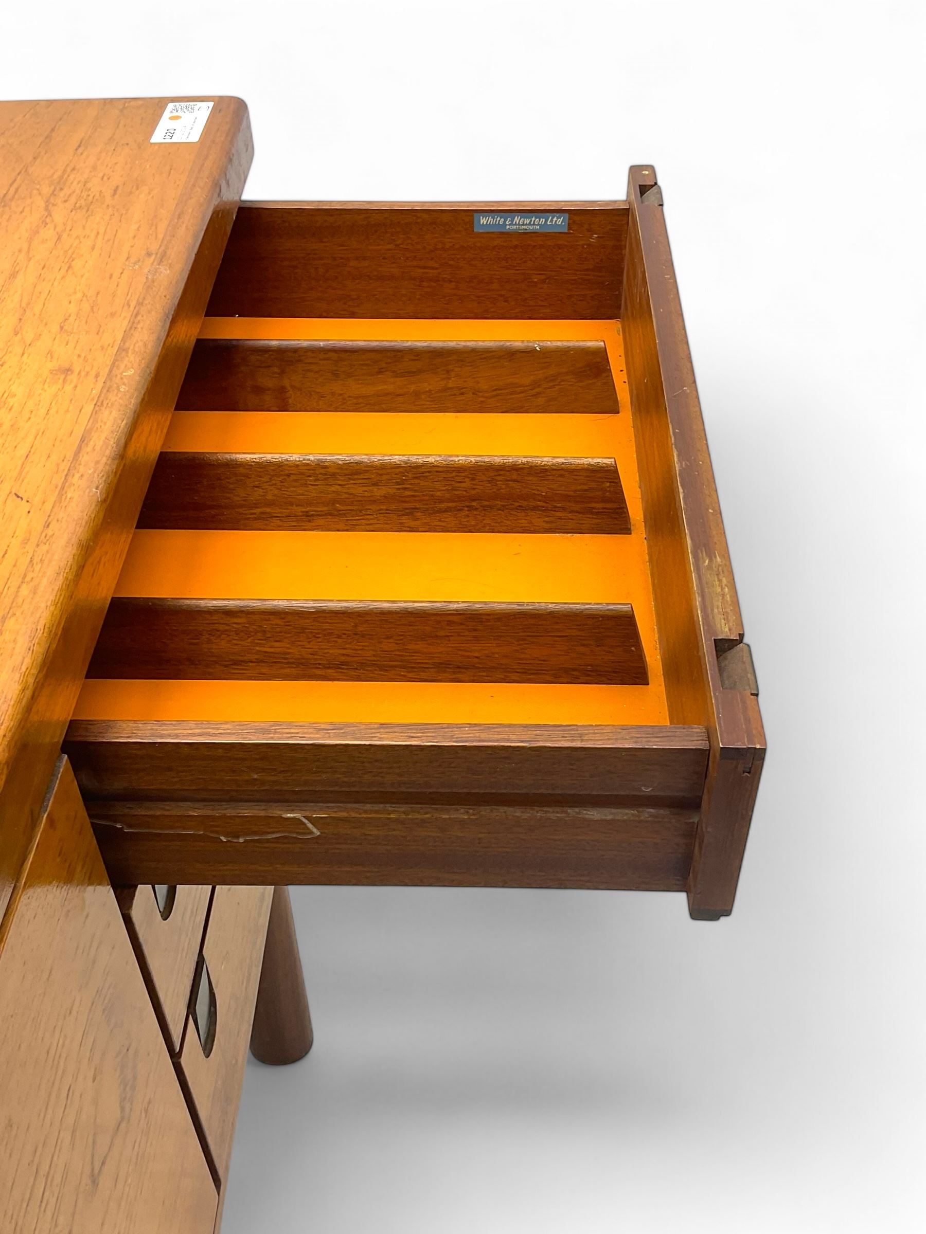 White & Newton - mid-20th century teak sideboard, rectangular top with raised back over fall-front storage compartment, double cupboard and three drawers, raised on cylindrical supports