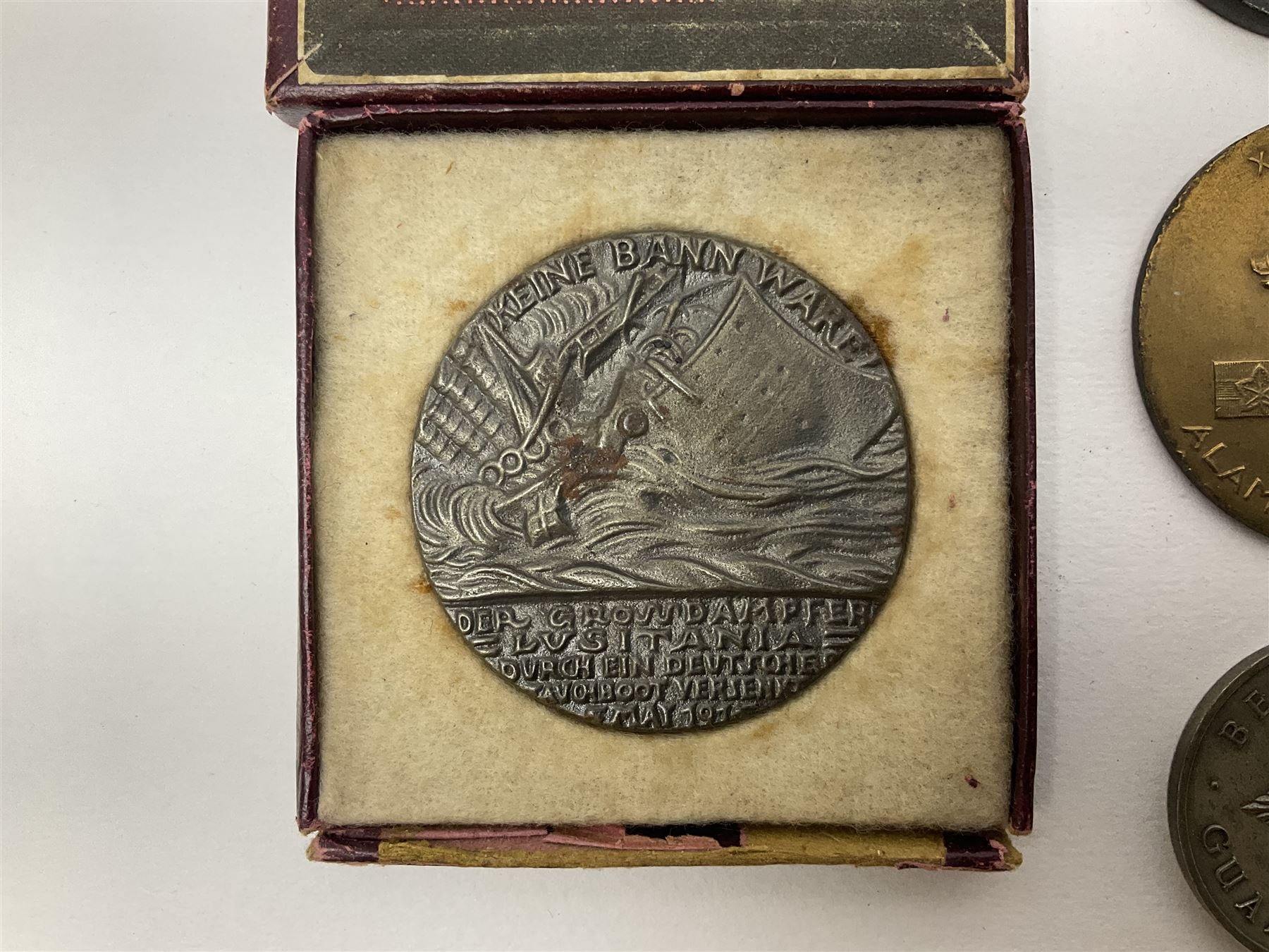 RMS Lusitania iron medallion dated 5th May, 5.5cm diameter, boxed with St Dunstan's Blinded Soldiers Profit paperwork; another unboxed similar Lusitania medallion; 30th Corps Alamein Cuxhaven medallion; Battle of Jutland 1916 silver memorial pendant; Navajo Code Talkers medallion 2000; and five other military related medallions