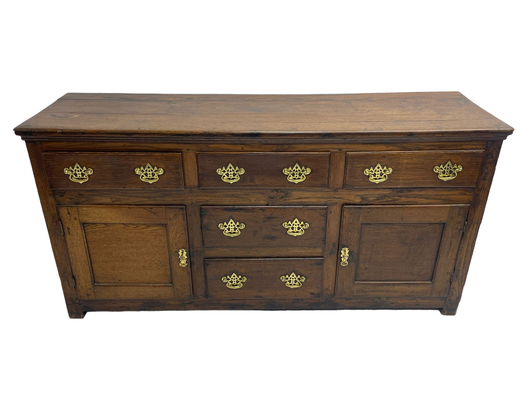 George III country oak dresser base,  rectangular top over with three central drawers flanked by two drawers and two panelled cupboards, each with moulded fronts, on stile feet