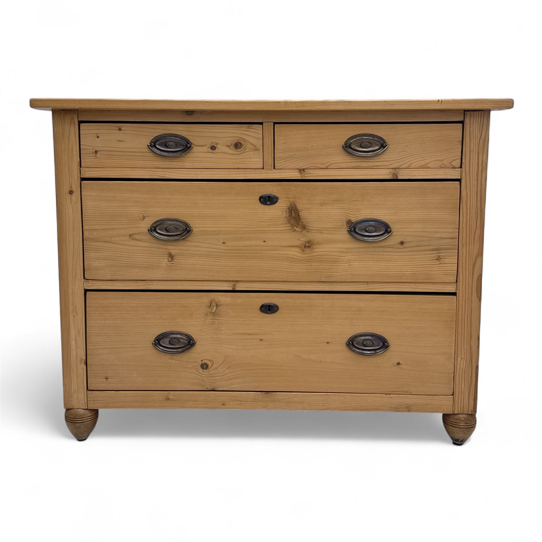 19th century pine chest of drawers, rectangular top over two short and two long drawers with oval pressed brass backplates and drop handles, panelled sides, rounded front edges, on compressed bun feet