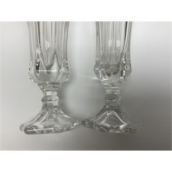 Pair of American depression glass flute shaped vases each of pedestal form moulded with the patriotic symbols of an eagle, the Liberty Bell and Statue of Liberty flaming torch H20cm