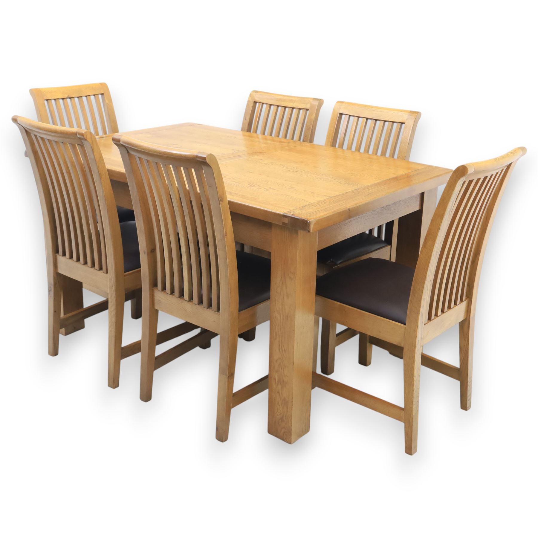 Contemporary oak extending dining table, moulded rectangular top with visible grain and inset extension leaf, pull out extending mechanism, standing on four square legs, accompanied by a set of high slat back chairs with upholstered brown faux leather seats and square tapering supports joined by stretchers