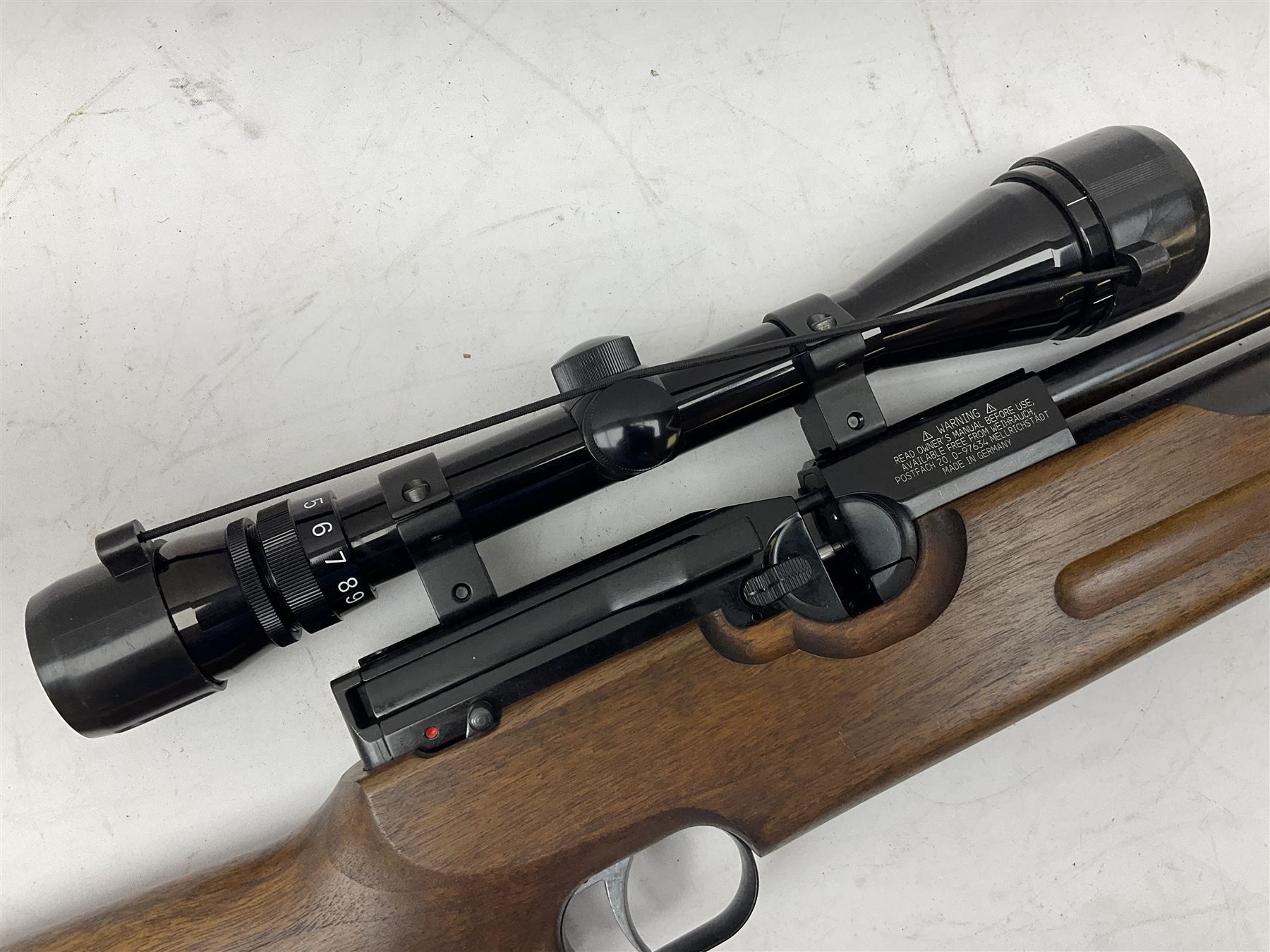 Weihrauch HW100 .22 calibre PCP repeating air rifle; walnut thumbhole stock with textured pistol-grip; Nikko Stirling Silver Crown 3-9x40 telescopic sight; integral sound moderator; No.1901181 L99cm overall; in gun sling; with Logun Combi-Pump and quantity of pellets