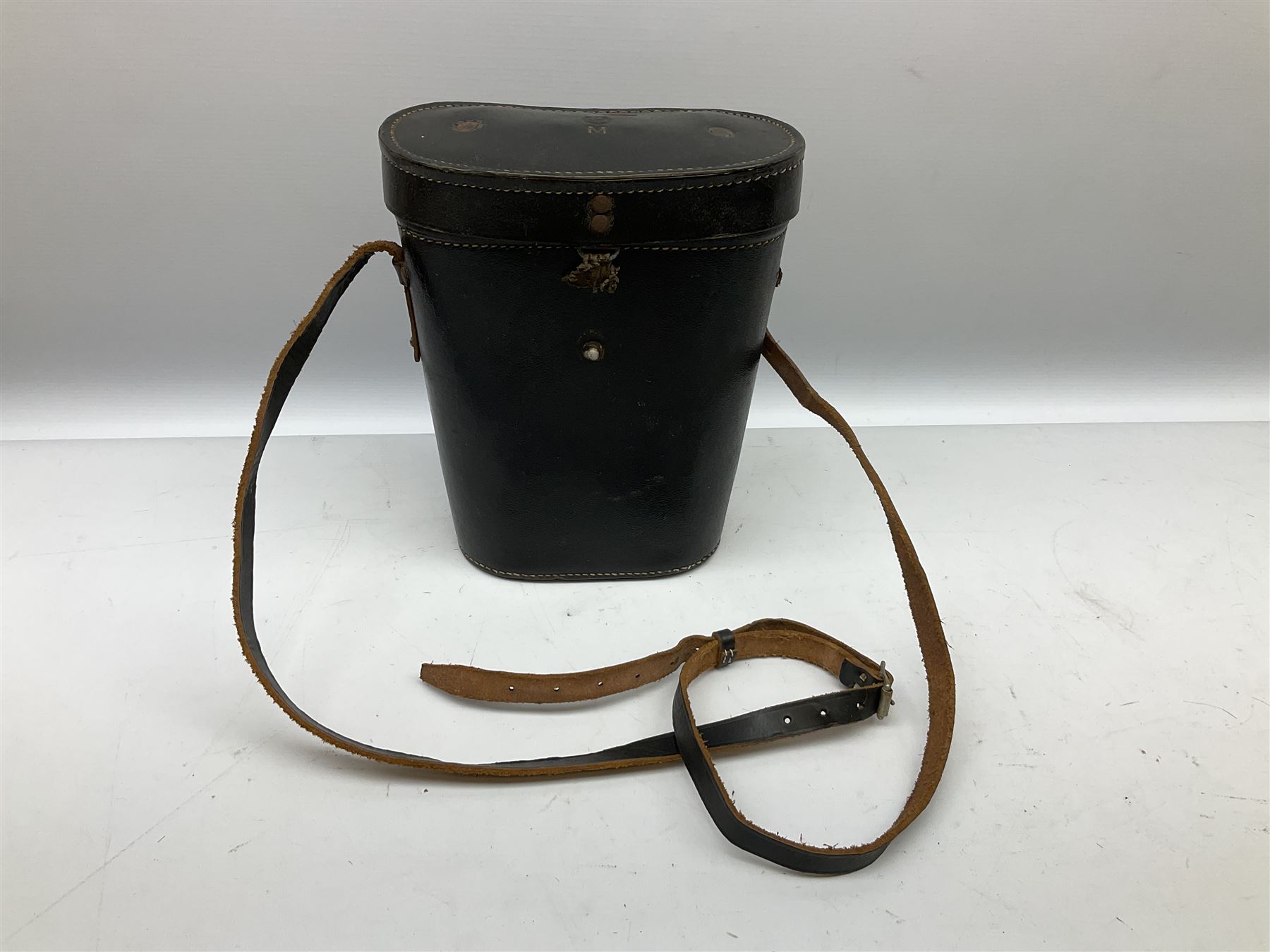 Pair of WWII German U-boat binoculars probably 7 x 50 by Leitz, with rubber eye piece protector covers and leather case stamped with Kriegsmarine mark to the lid and dated 1944, with leather strap.