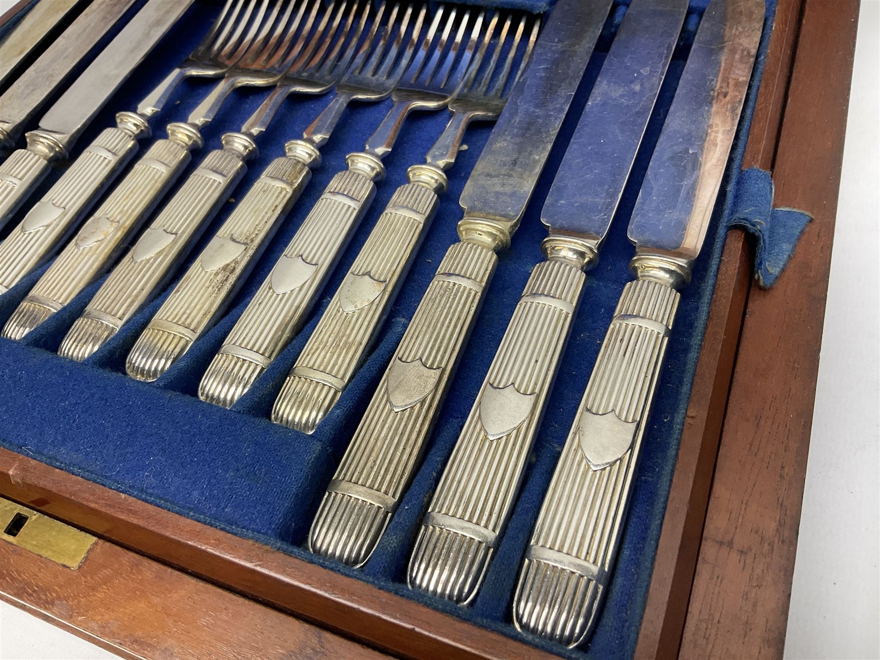 Victorian silver plated dessert set by Elkington & Co for twelve place settings, each reeded handle with vacant cartouche, each with Elkington & Co mark, date letter for 1861, and registration lozenge, contained within a mahogany case with vacant brass cartouche to the hinged cover, opening to reveal a Royal blue baize lined interior with removable tray, case H6cm W29.5cm D26.5cm