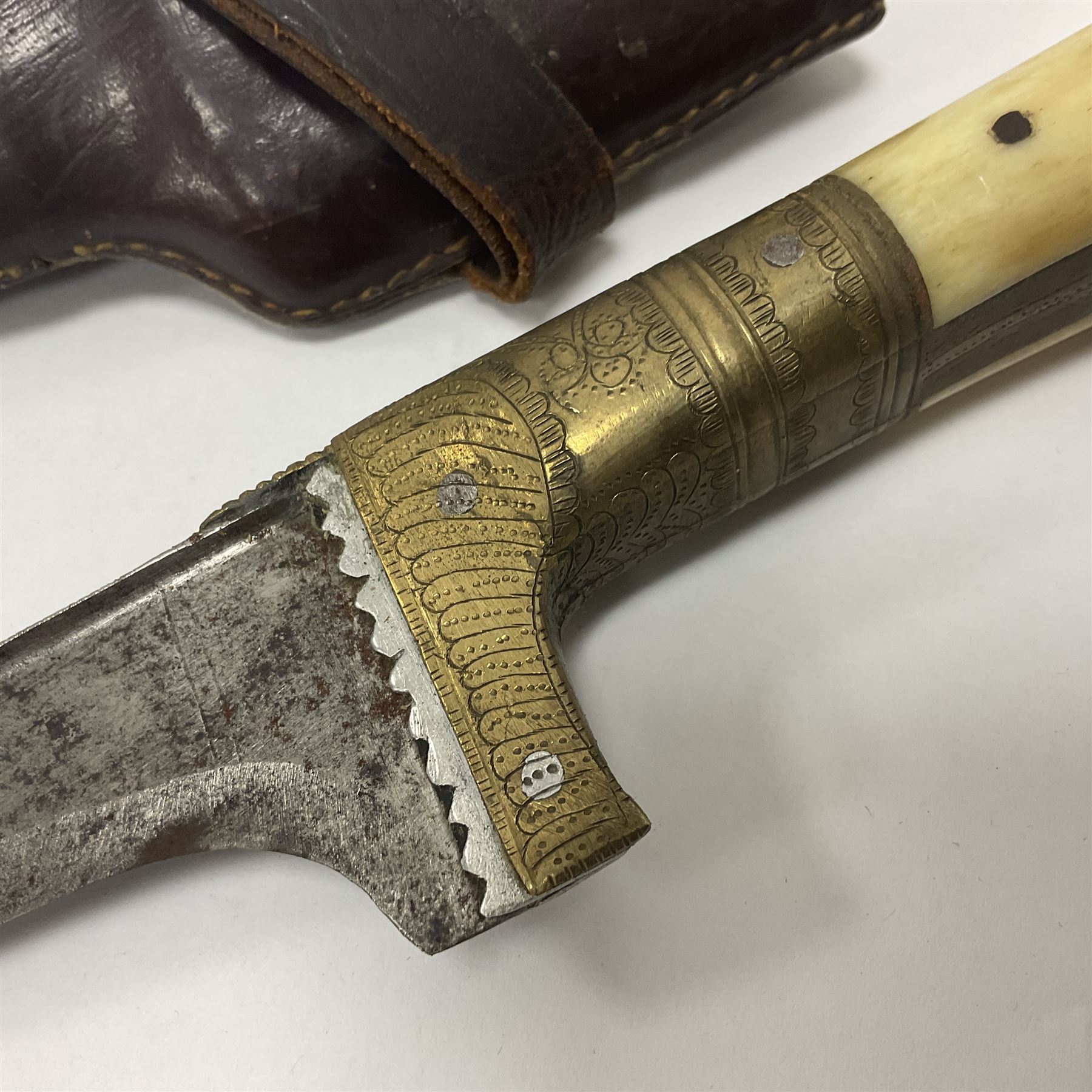 Afghan Khyber knife (Choora), blade engraved along the top edge with ornate brass and bone grip, with leather scabbard, overall L31cm, blade L20cm