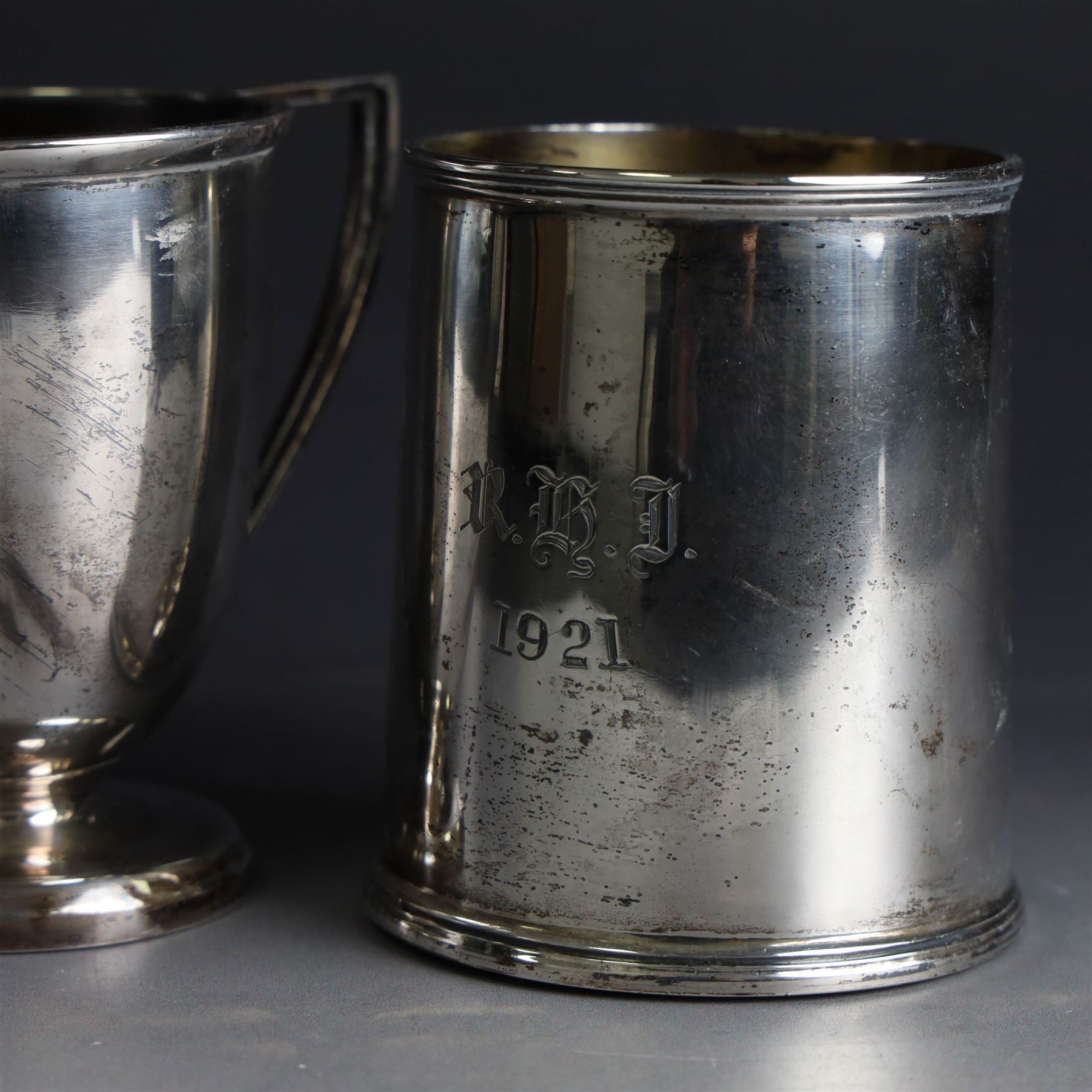 Two early 20th century silver christening mugs, both with engraved initials, both hallmarked, tallest H7.5cm