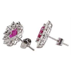 Pair of 18ct white gold oval ruby and round brilliant cut diamond stud earrings, stamped 18K, total ruby weight approx 3.15 carat, total diamond weight approx 2.15 carat