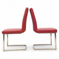 Set of seven contemporary style dining chairs, each with a high padded back and seat upholstered in faux leather on brushed steel sled bases  