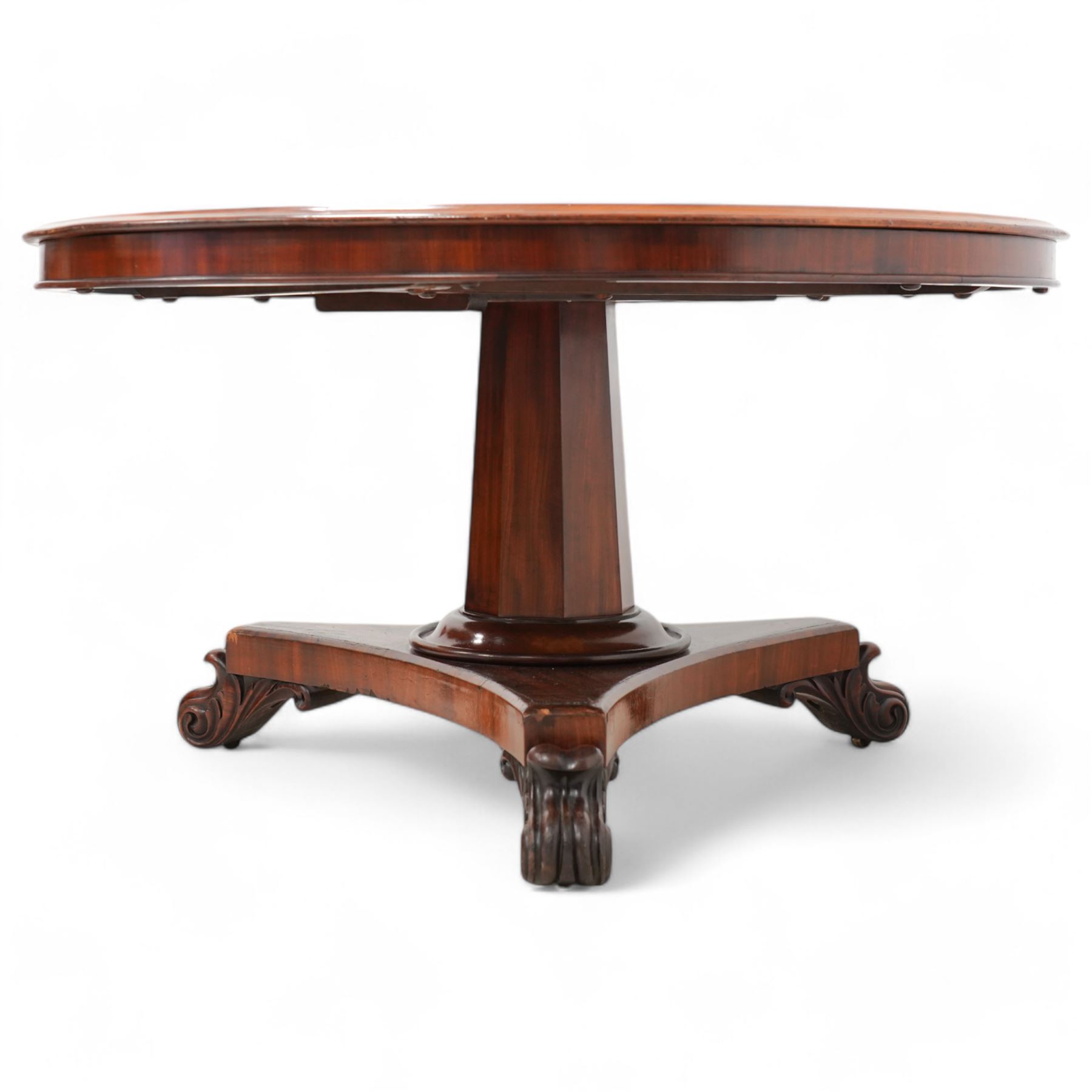 Early Victorian figured mahogany centre or breakfast table, circular moulded tilt-top, tapered octagonal column on triangular platform, acanthus leaf and scroll carved feet 