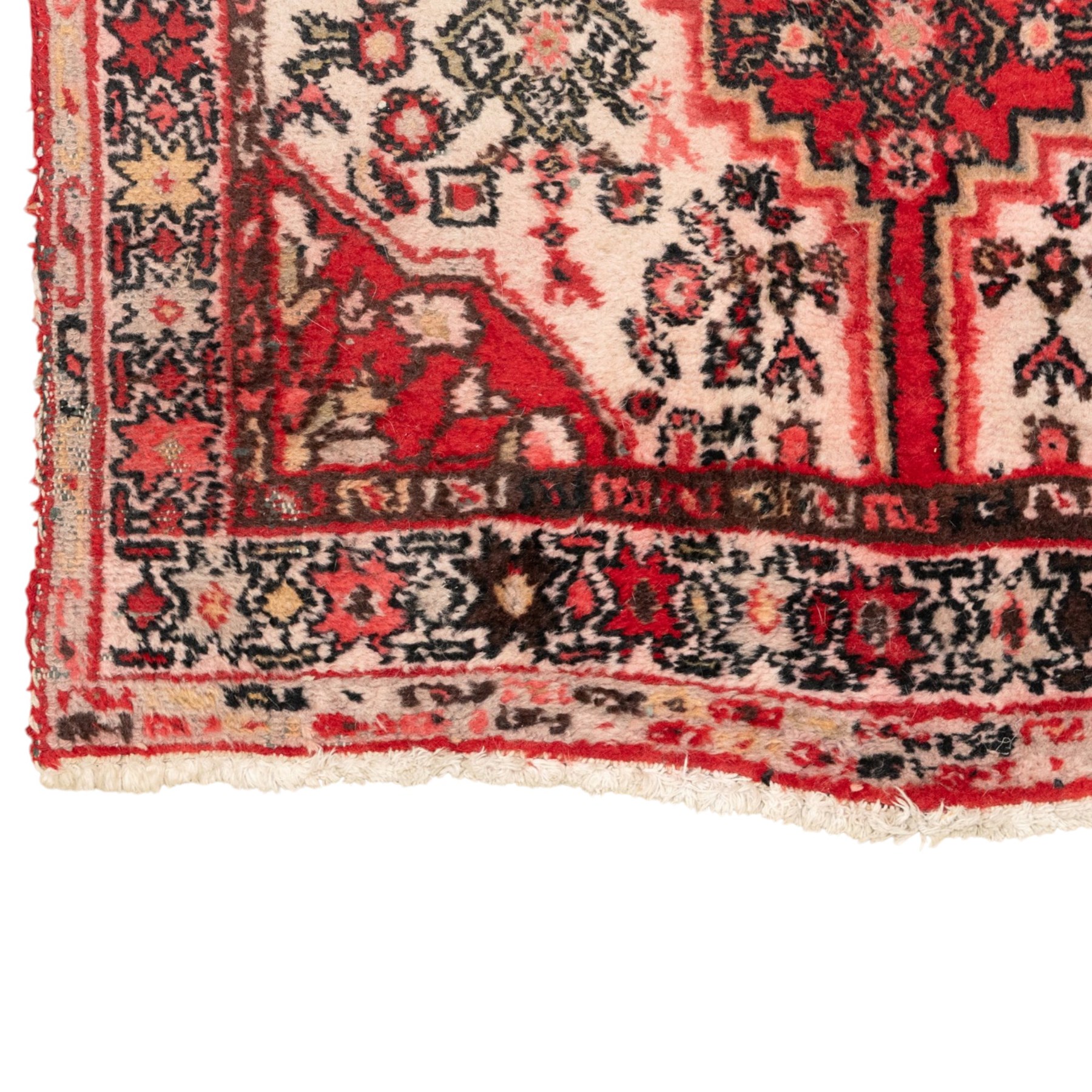 Persian crimson ground runner rug, the field decorated with repeating Herati motifs around an ivory pendant medallion, stepped ivory spandrels with stylised floral ornament, enclosed by a dark ground star border and narrow guard stripes