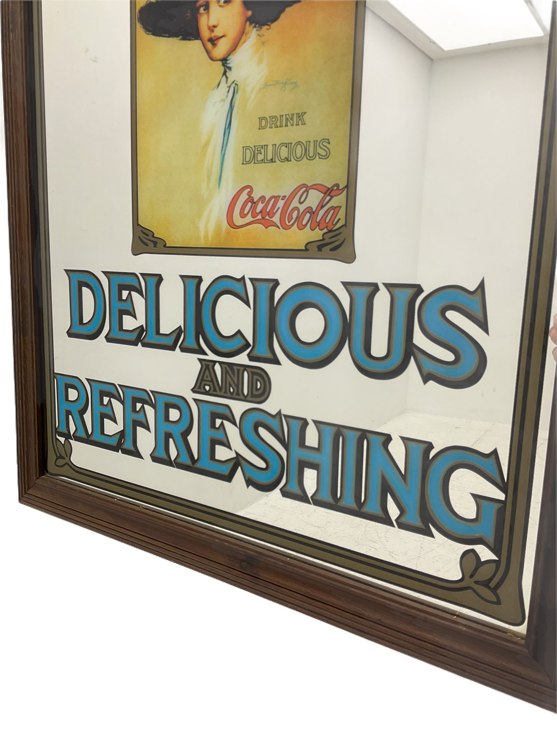 Late 20th century 'Coca Cola' style mirror (64cm x 89cm), and a 20th century frameless mirror (44cm x 67cm)
