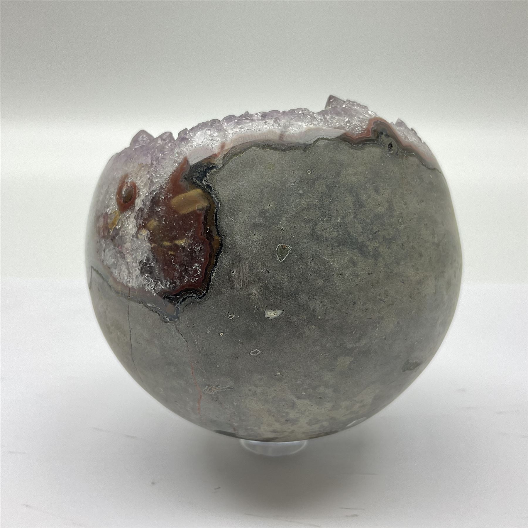 Pair of amethyst geode spheres, with purple crystalline internal formations, D9cm