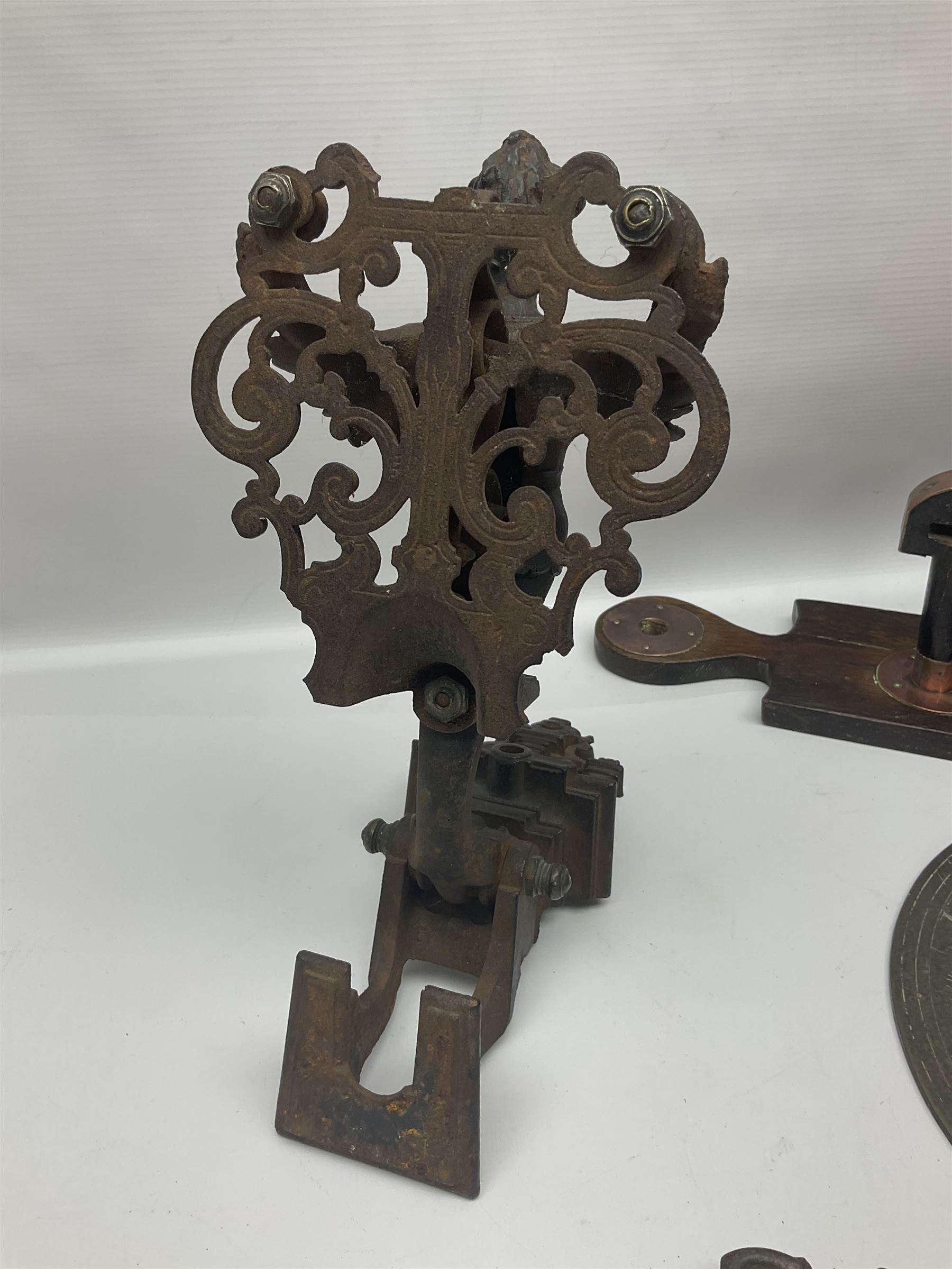 Two 19th century copper tankards, one with weighted wooden base, together with copper and wooden mechanical bellows, sundial and other metalware 