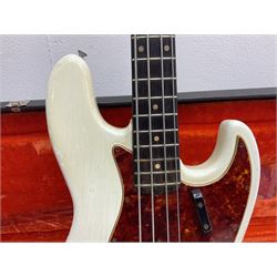 1963 Fender Jazz three-knob bass guitar; impressed with date code 7AUG63A on end of neck and serial no.L08587 on back plate; all original but re-finished in white in the 1970s; sold with photographs of the instrument in the 1960s with original finish and in the 1970s re-finished; L117.5cm; in original hard carrying case; Provenance: the professional guitar of Howard Livett from new to his death in 2005. Howard played in The Humperdincks, the backing group for Englebert Humperdinck, also played in the backing group for Max Bygraves and in the band Hedgehoppers Anonymous. The guitar is also sold with a manuscript letter of provenance from Howard's wife.