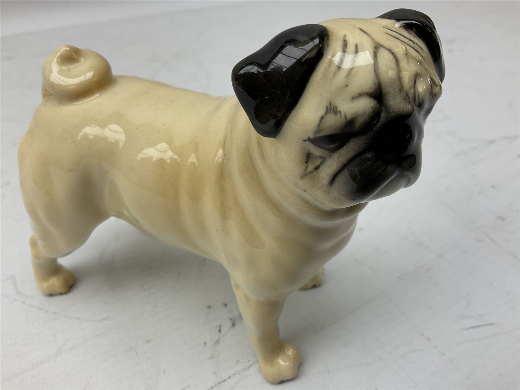 Three Beswick models comprising Hereford Bull no 949, 'CH Cutmil Cupie' Pug, and bay Shire horse, all with printed marks beneath