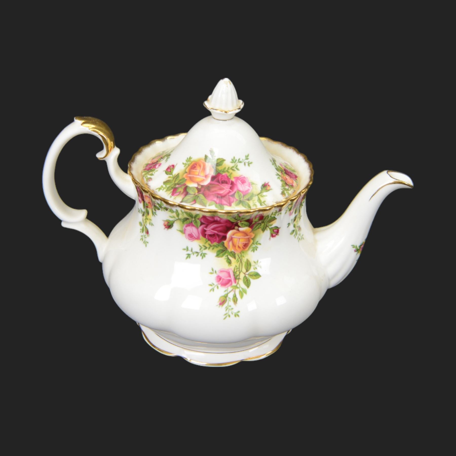 Royal Albert Country Roses tea and dinner service for six place settings, comprising teapot, milk jug, cups and saucers, dessert plates, side plates and dinner plates, all with printed mark beneath 