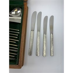 A canteen of bark effect stainless steel cutlery by Gerald Benney for Viners Studio, in a teak case. 