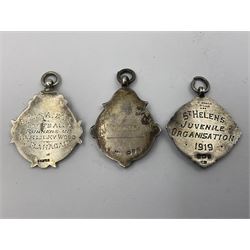 Seven early 20th century silver fobs, all embossed with sporting scenes, to include a gold faced example depicting a cricketing scene, hallmarked Chester 1932 and one depicting a tennis scene, all hallmarked with various dates and makers
