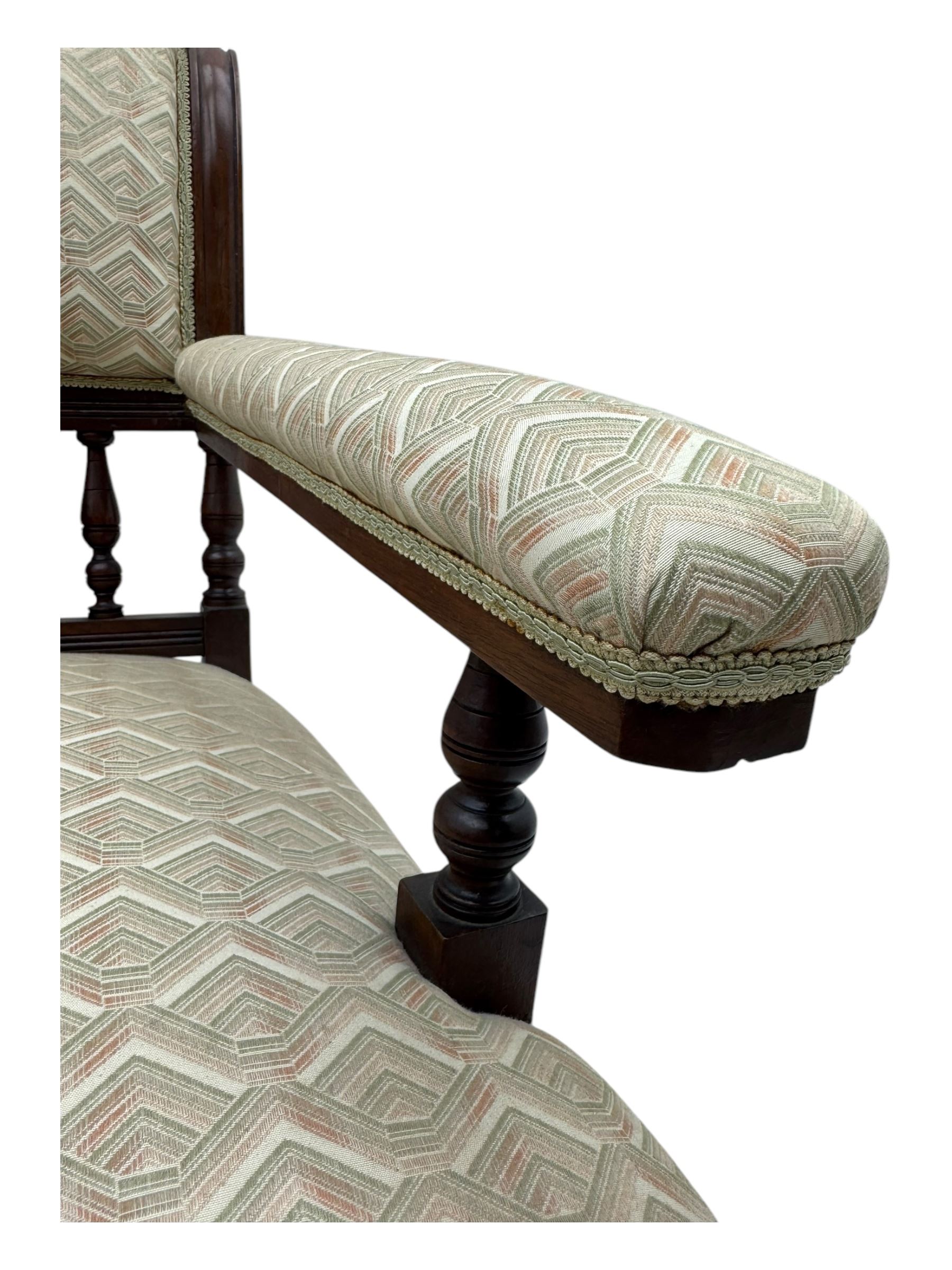 Late Victorian mahogany framed armchair, scroll back with spindle gallery, upholstered seat back and arms