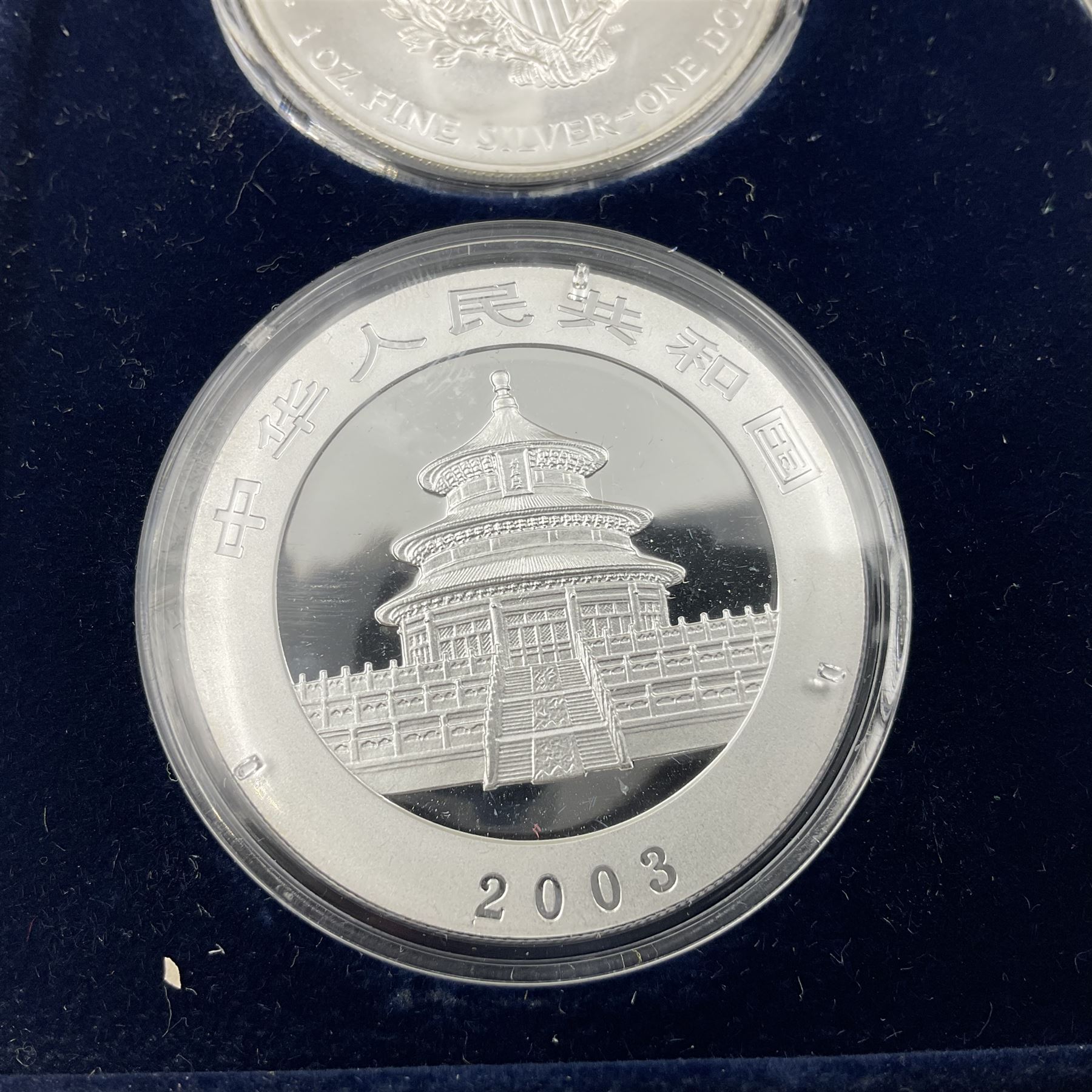 Four one ounce fine silver coins, forming 'The 2003 Famous World Silver Coin Collection', comprising United States eagle, Australian kangaroo, Chinese panda and Canadian maple leaf, cased with Westminster certificate 