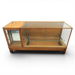Early 20th century oak framed and glazed haberdashery shop counter with sliding doors and cupboards