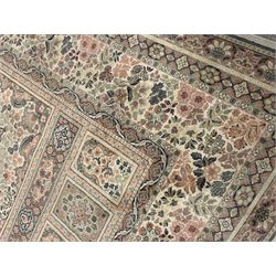 Large Persian design rug carpet, pale ground with large central rosette medallion, the field divided into multiple rectangular panels, overall floral decoration, repeating border