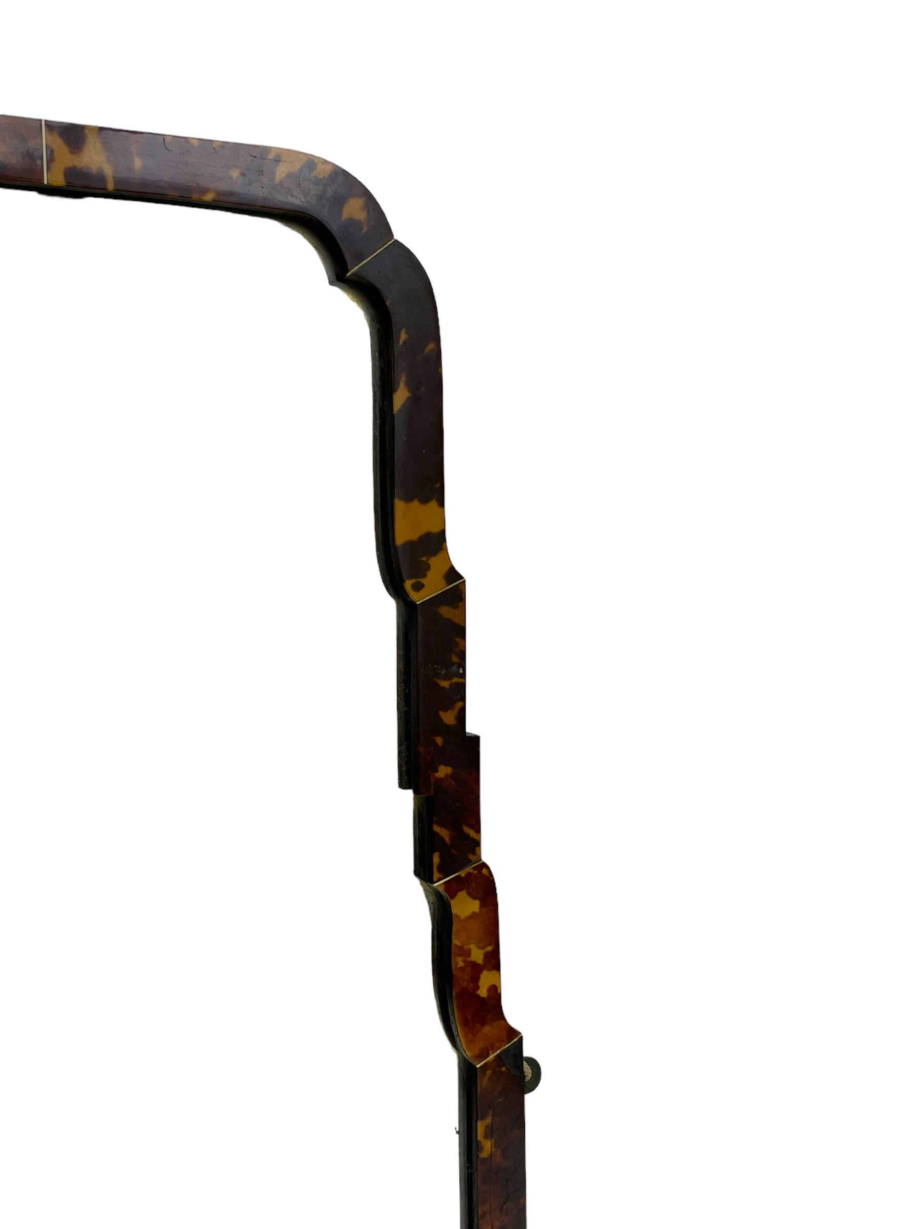 Early 20th century wall hanging tortoise shell framed mirror, of rectangular form, the upper half of the frame shaped and stepped surrounding a plain mirror plate