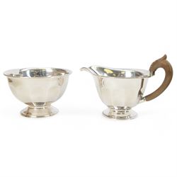 1930s silver three piece tea service, comprising teapot, open sucrier and milk jug, each of circular part fluted form, the jug and teapot with Bakelite type handles, hallmarked Viner's Ltd,  Sheffield 1935