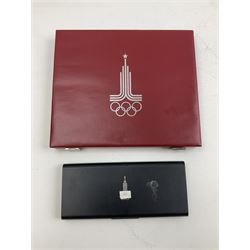 Russian 1980 Moscow Olympic Games silver twenty eight coin set, housed in dated red case and four other coins relating to the Olympics, housed in dated black case